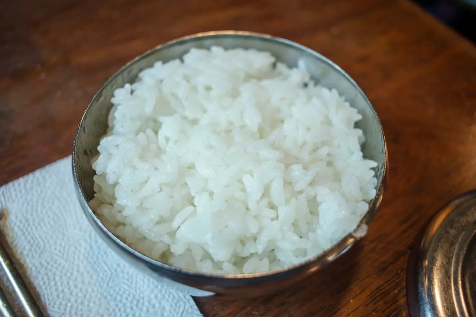 Steamed white rice served in a small metal bowl