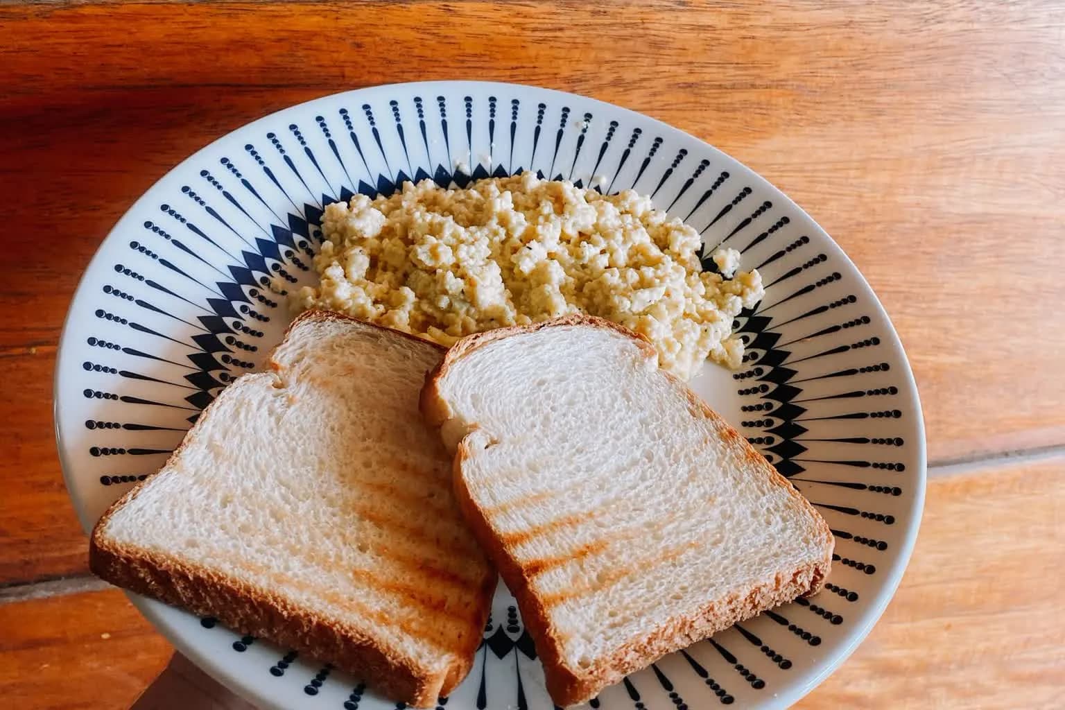 A plate of soft scrambled eggs served with toast